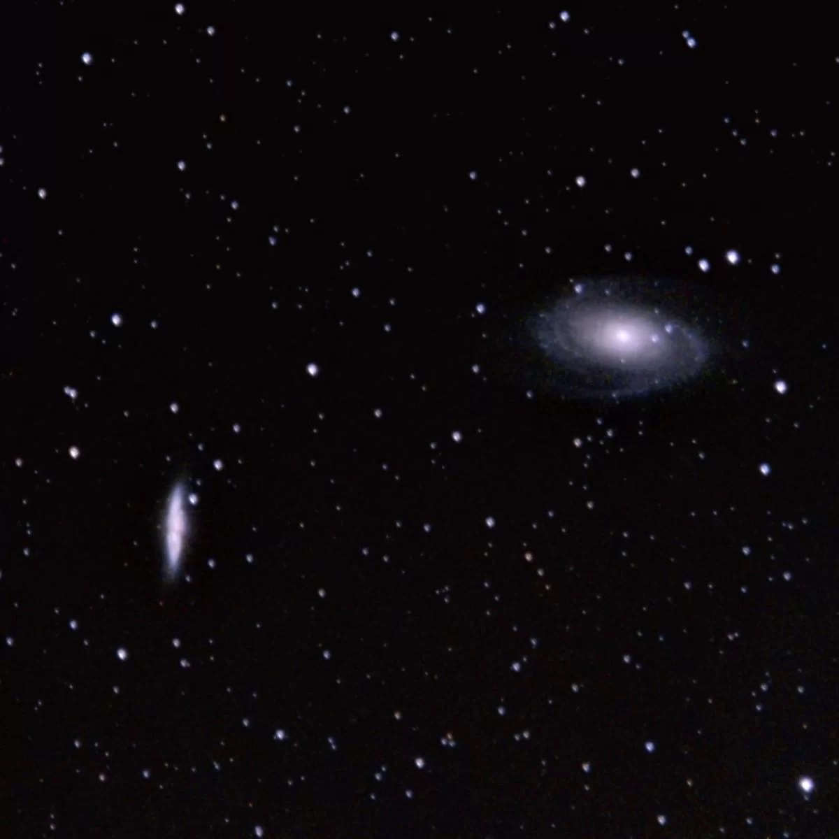 Figure 7 | Cigar Galaxy (M82, left) and Bode's Galaxy (M81, right). Photographed on 4/8/2021 from Flanders, NJ, using a Canon EOS RP with a Sigma EX DG OS 70-200mm f/2.8 lens and a 2x Sigma APO Teleconverter at f/8, and ISO 3200 on a Sky-Watcher Star Adventurer 2i Pro tracking at sidereal rate. The rig was used in full-frame mode for a total raw focal length of 400mm. 63x120s images were integrated within Sequator for a total of 2.1h of data; the output TIFF was then stretched in Adobe Photoshop CC v. 22.1.1 using the Astronomy Tools Action Set (v. 1.6.2 from ProDigital Software) and AstroFlat Pro (v. 1.4.11 from ProDigital Software). 