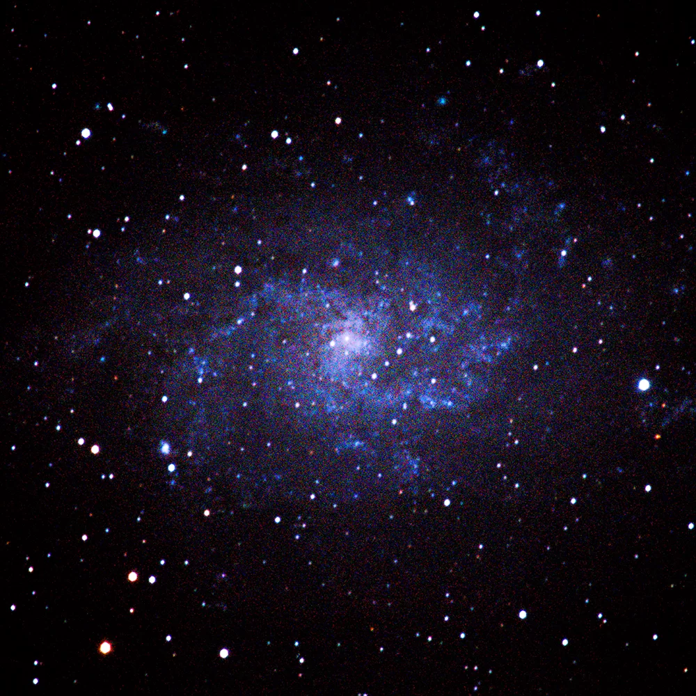 Figure 15 | The Triangulum Galaxy (M33). Photographed on 11/5/2021 from Flanders, NJ, using a Canon EOS RP with a Sigma 150-600mm DG OS HSM f/5-6.3 lens and a 2x Sigma APO Teleconverter at f/13, and ISO 1600 on a Sky-Watcher Star Adventurer 2i Pro tracking at sidereal rate. The rig was used in cropped-sensor mode for a total raw focal length of 1920mm. 36x120s images were integrated within DeepSkyStacker for a total of 112 min of data; the output TIFF was then stretched in Adobe Photoshop CC v. 22.1.1 using the Astronomy Tools Action Set (v. 1.6.2 from ProDigital Software) and AstroFlat Pro (v. 1.4.11 from ProDigital Software). 